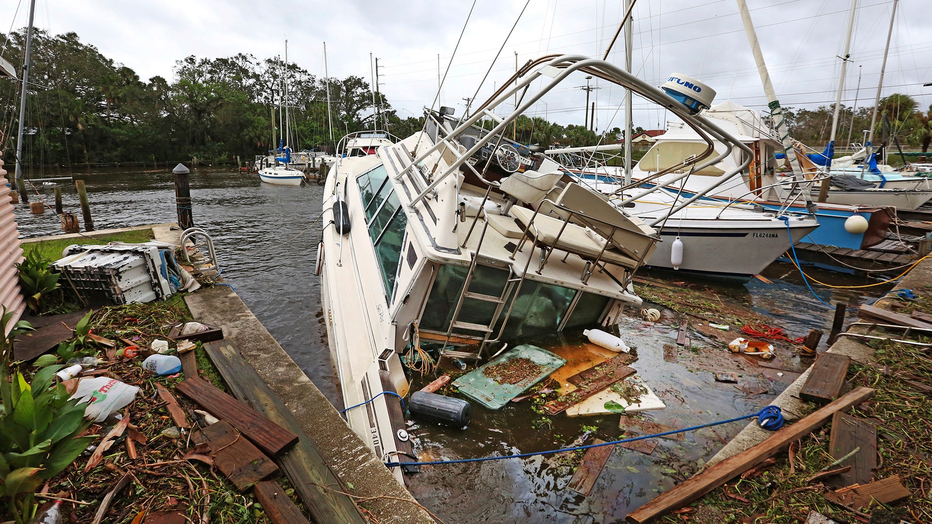 A sinking boat is surrounded by debris in the aftermath of Hurricane Irma at Sundance Marine in Palm Shores, Fla., Monday