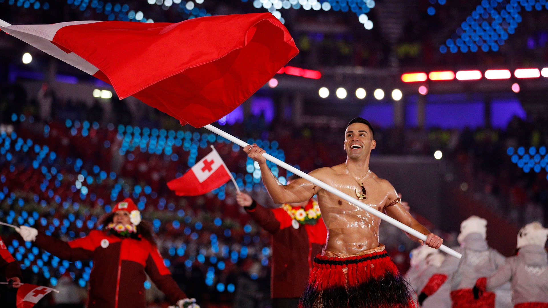 Pita Taufatofua carries the flag of Tonga during the opening ceremony of the 2018 Winter Olympics in Pyeongchang