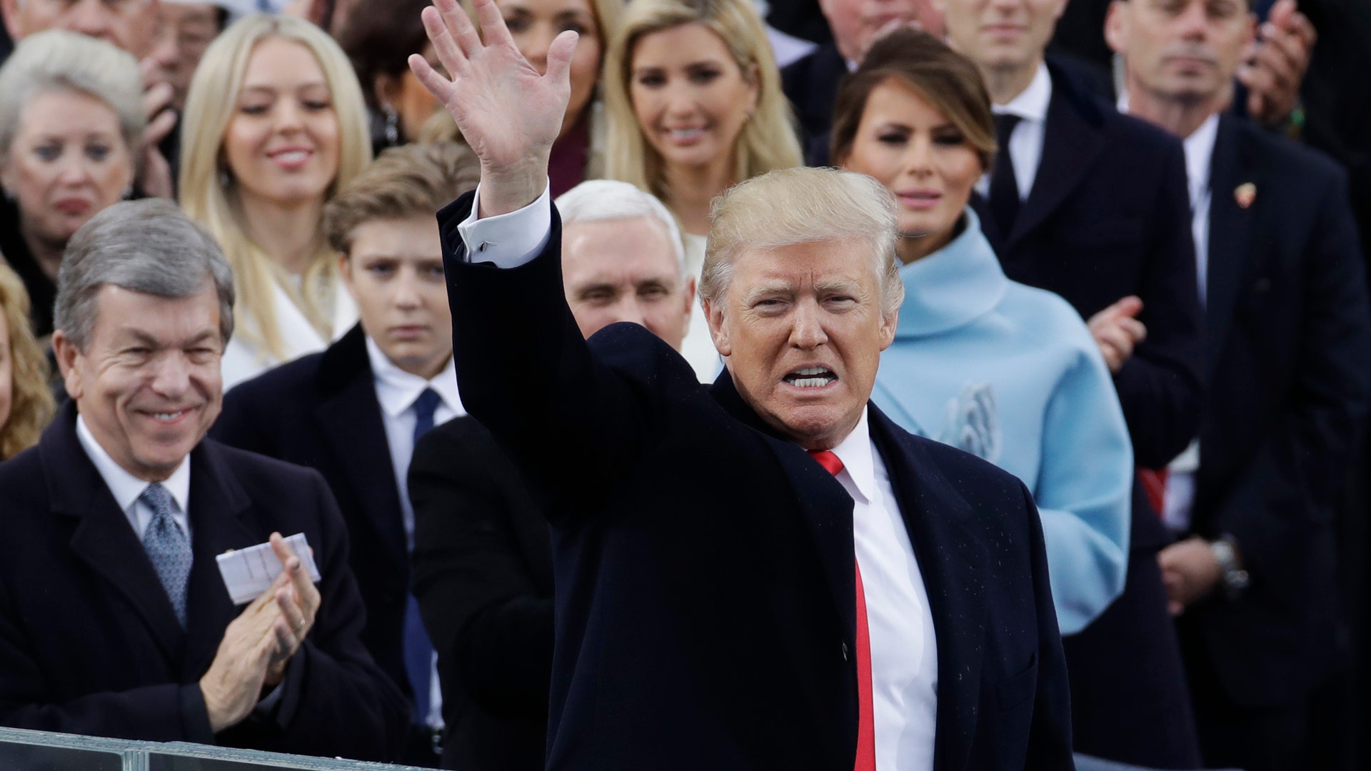 President Donald Trump waves after delivering his inaugural address after being sworn in as the 45th president of the United States during the 58th Presidential Inauguration.