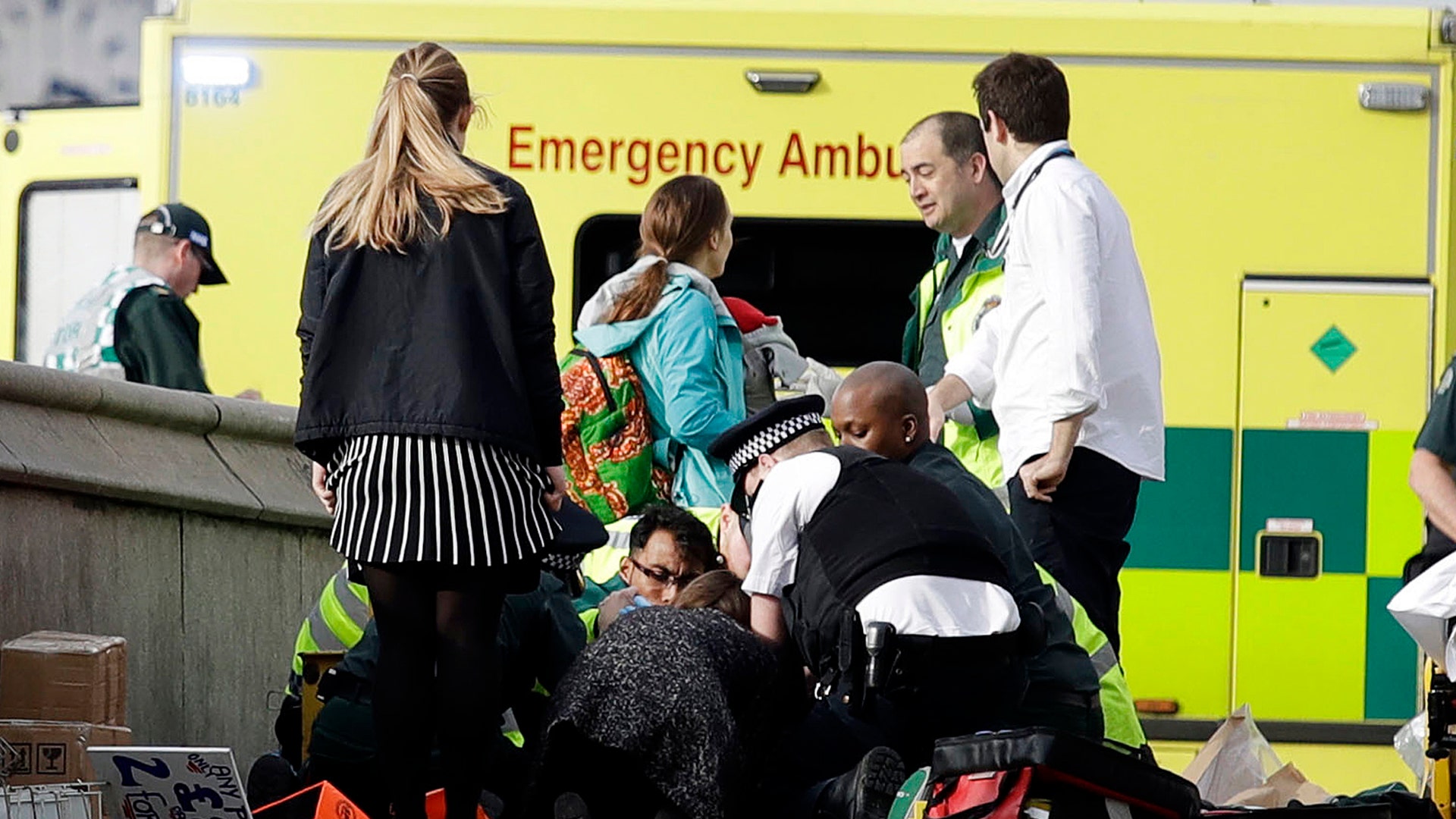 Emergency services staff provide medical attention close to the Houses of Parliament in London.