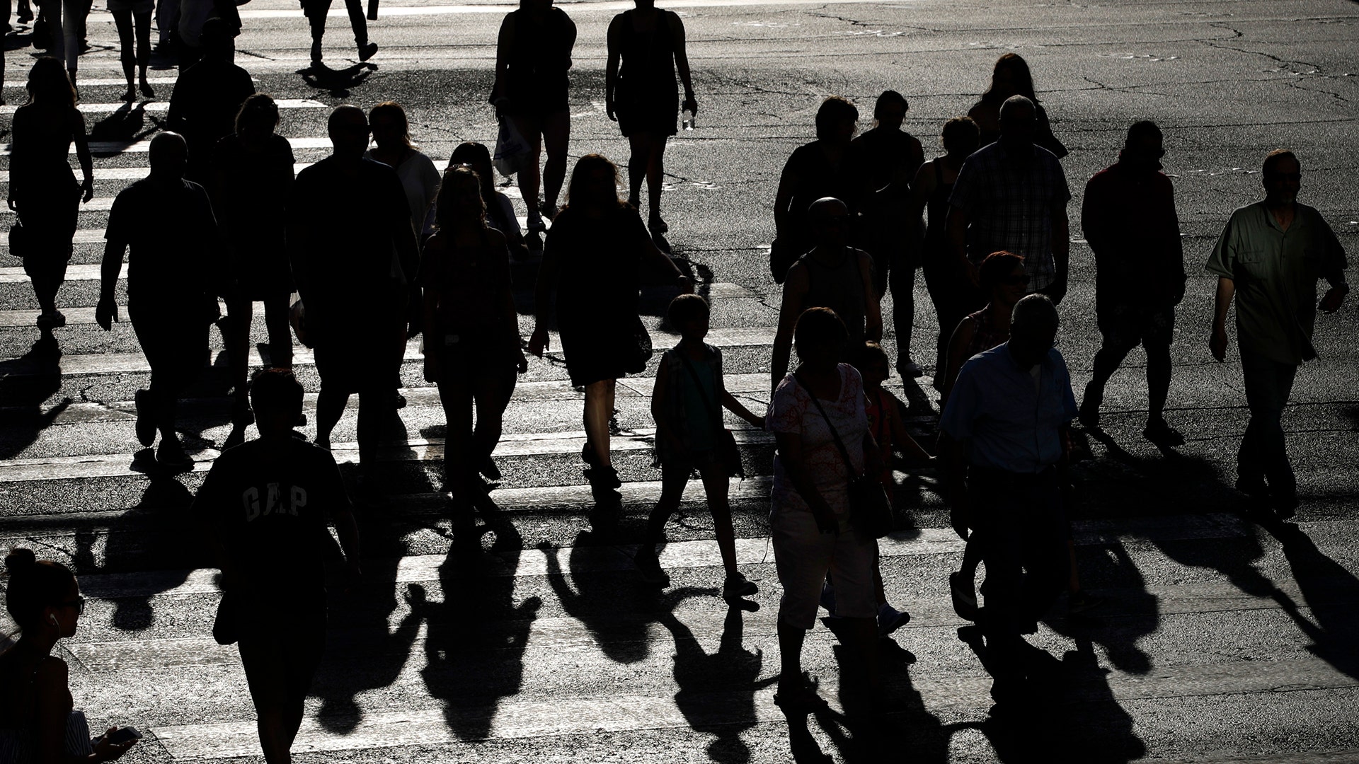 People cross Las Vegas Boulevard during a heat wave in Las Vegas, Tuesday