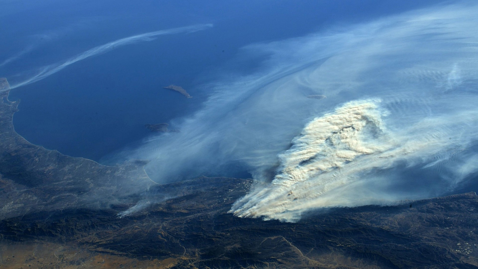 A photo taken from the International Space Station shows smoke rising from a wildfire burning in Southern California, Wednesday
