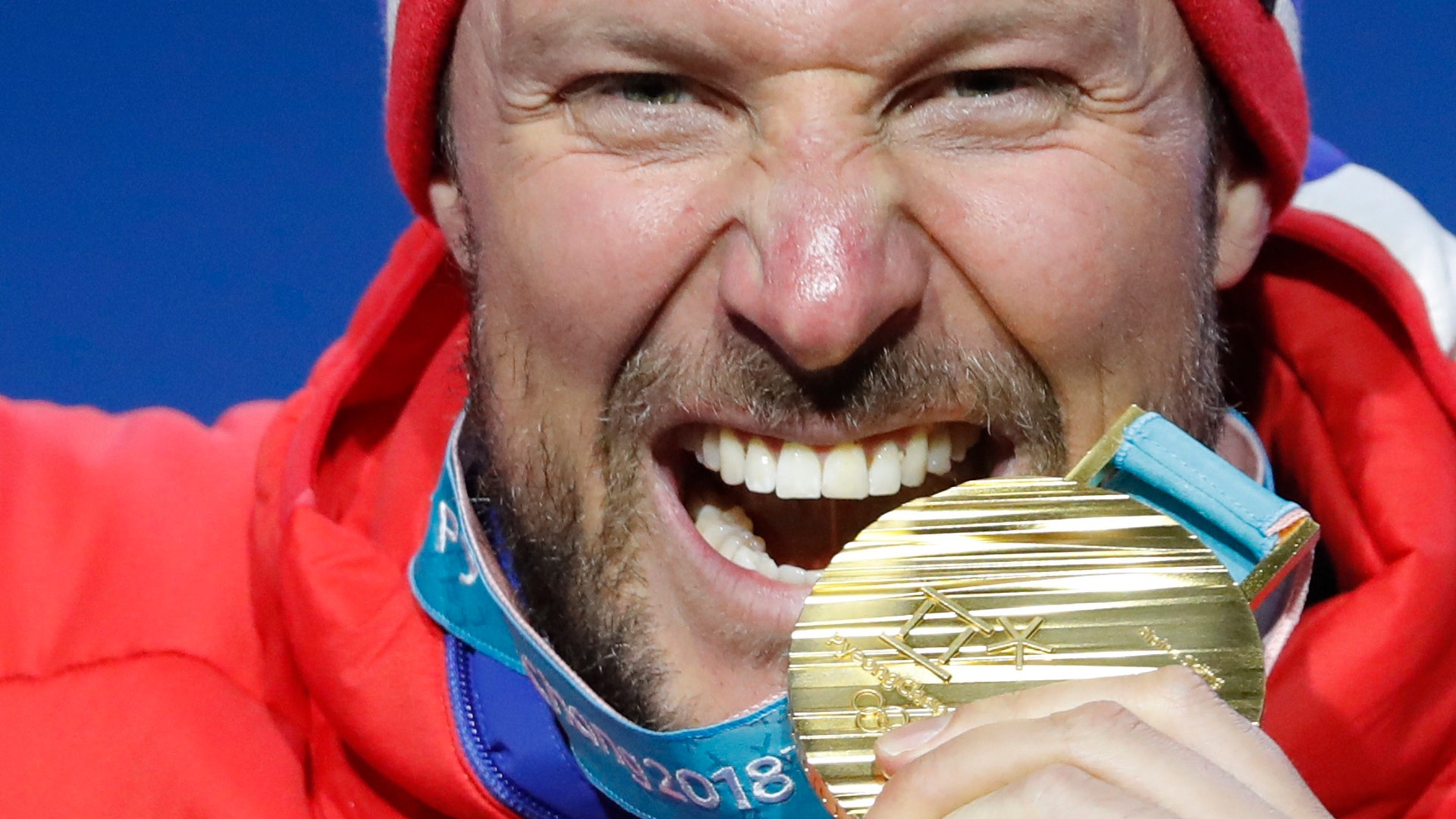 Aksel Lund Svindal of Norway with his gold medal after winning the men's downhill at the 2018 Winter Olympics