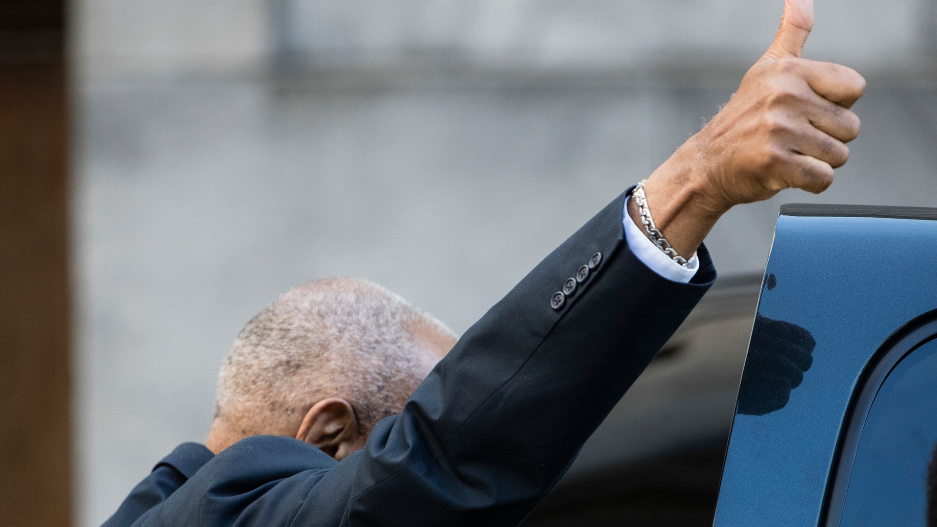 Bill Cosby gestures as he departs from the Montgomery County Courthouse during his sexual assault trial on June 9, 2017.