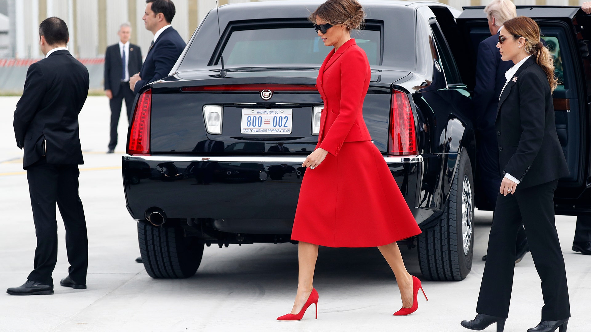 President Donald Trump and first lady Melania Trump part on the tarmac after they arrive on Air Force One in Paris