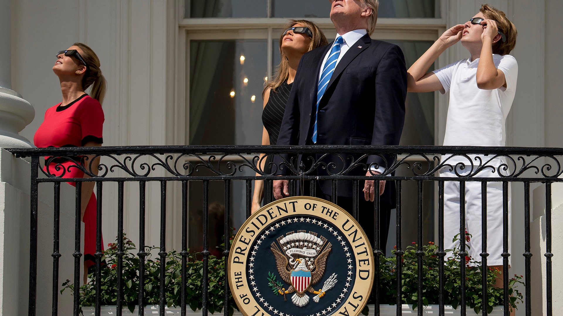 Ivanka Trump, first lady Melania Trump, President Donald Trump, and their son Barron Trump view the solar eclipse at the White House