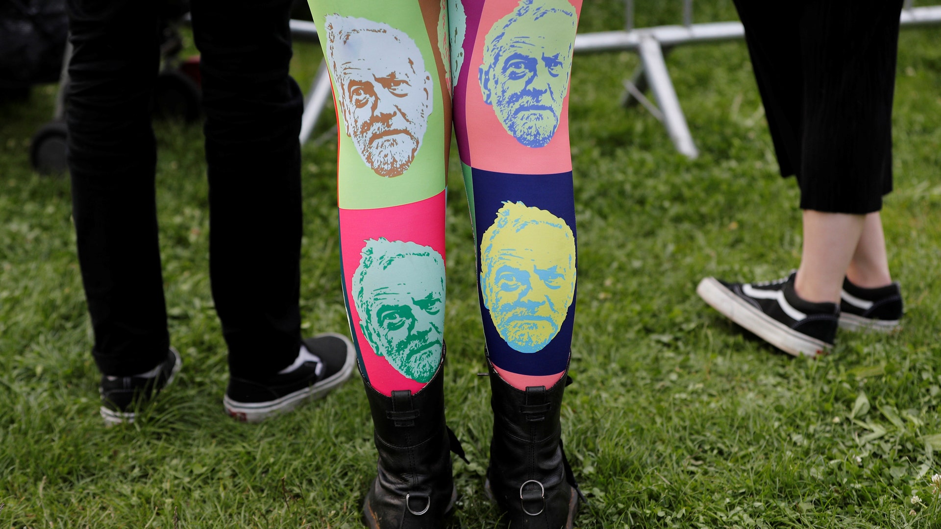 A woman wears tights showing the face of Labor leader Jeremy Corbyn at a campaign rally in Birmingham