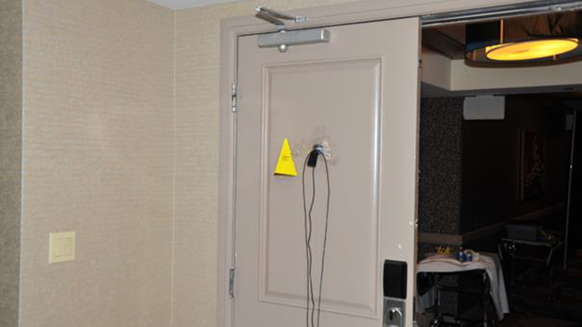 Surveillance camera mounted to room door peephole