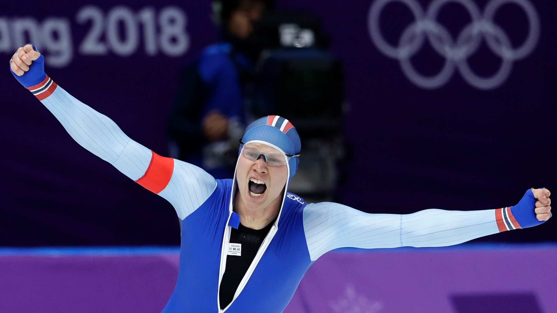 Gold medalist Havard Lorentzen of Norway celebrates setting a new Olympic record during the men's 500 meters speedskating race