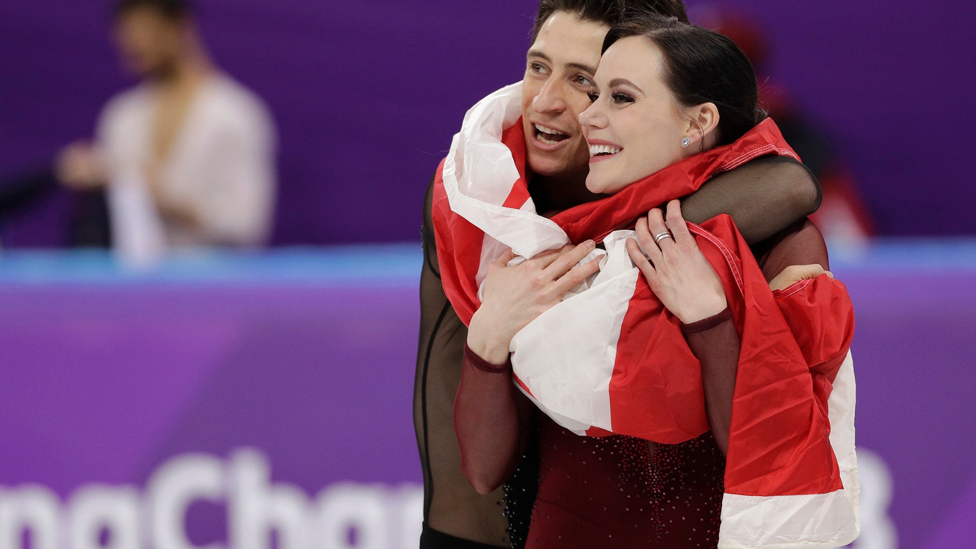 Tessa Virtue and Scott Moir of Canada during the venue ceremony after winning the gold medal in the ice dance at the Winter Olympics
