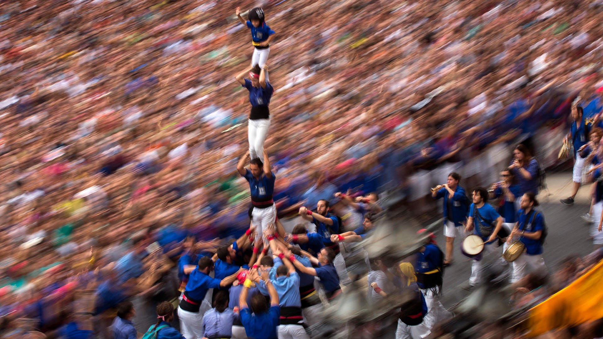 Members a casteller walk maintaining a human tower or 