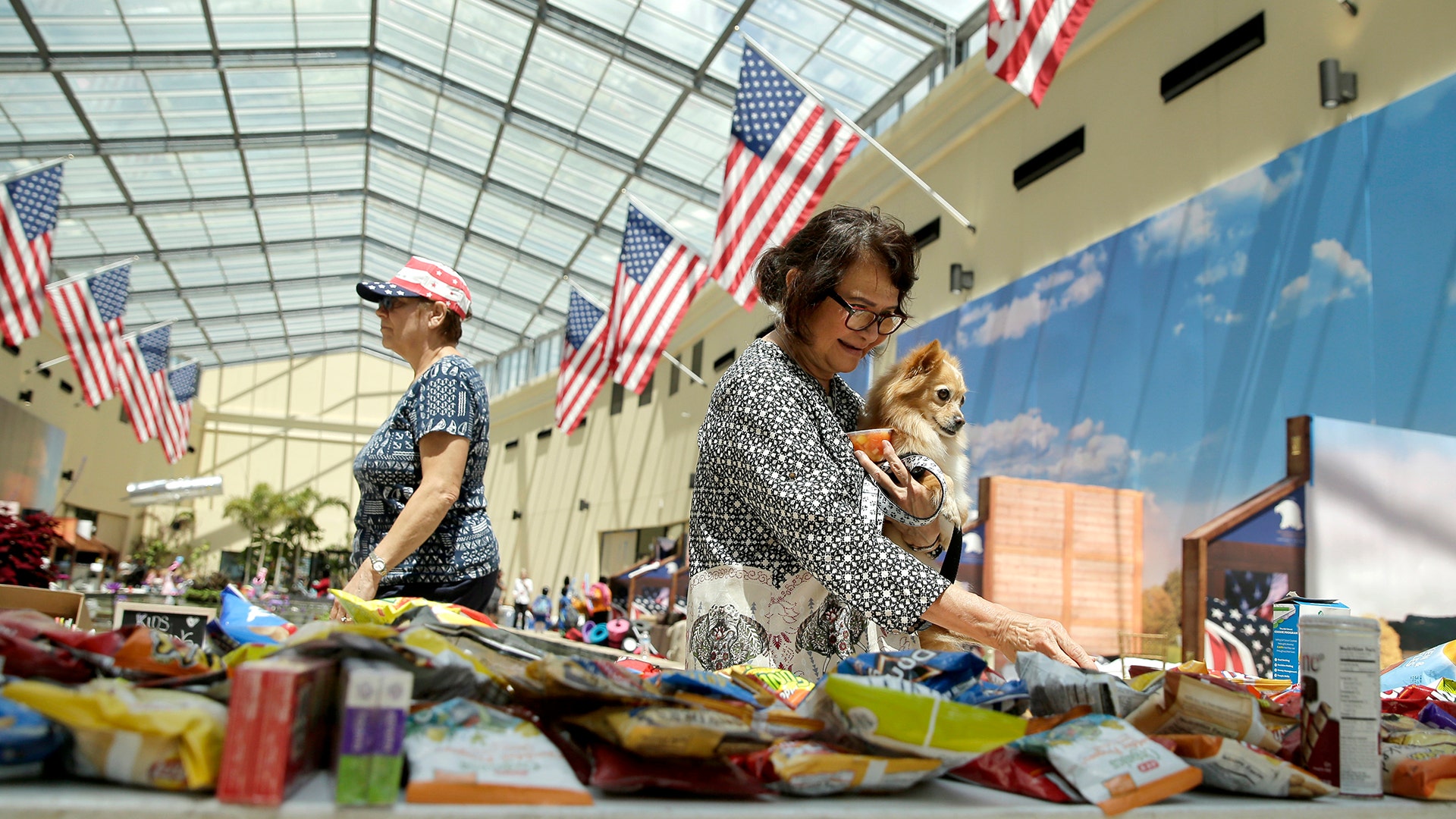 Anna Koh selects a snack while sheltering at Gallery Furniture Wednesday, in Richmond, Texas