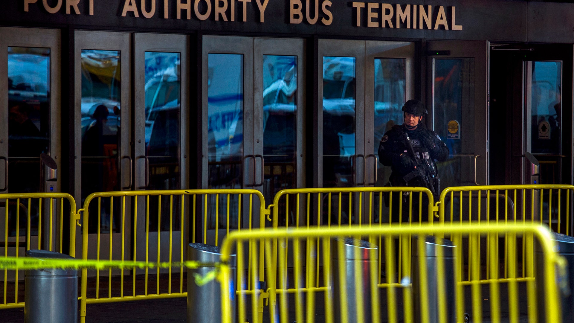 A police officer stands guard in front of Port Authority Bus Terminal in New York City, Monday
