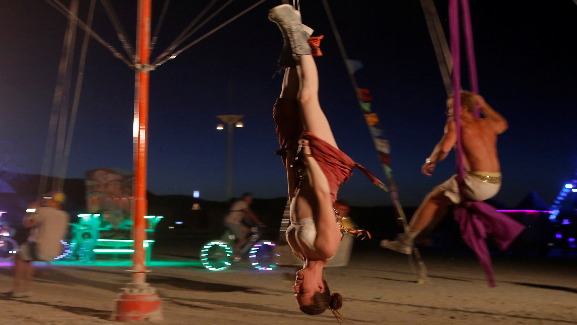 A participant rides a swing at the Burning Man arts and music festival in the Black Rock Desert of Nevada, August 28