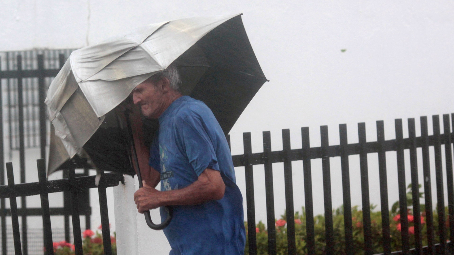 A man walks on a street as Hurricane Irma howls past Puerto Rico after thrashing several smaller Caribbean islands, in Fajardo, Puerto Rico