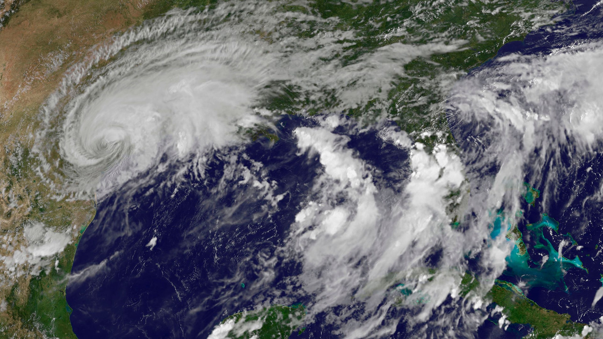 This enhanced satellite image made available by the NOAA GOES Project shows Harvey, upper left, over Texas on, Aug. 26