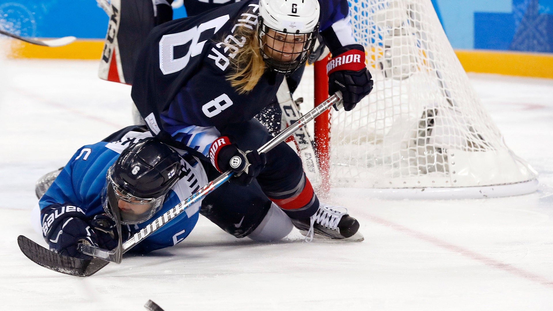 Jenni Hiirikoski of Finland and Emily Pfalzer of U.S. during their women's ice hockey game at the 2018 Winter Olympics