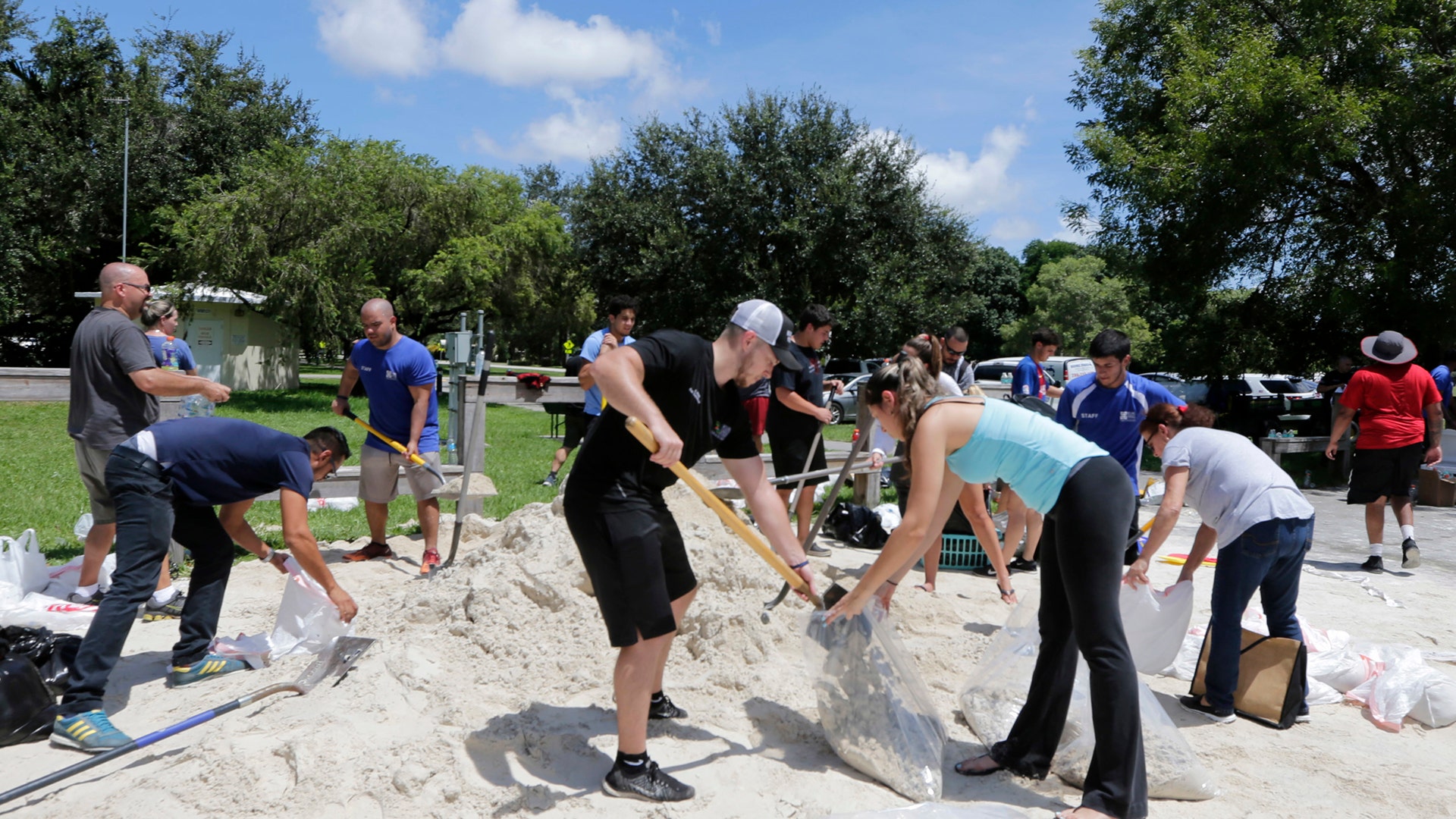 City of Miami volunteers help residents fill free sandbags in Miami, Thursday