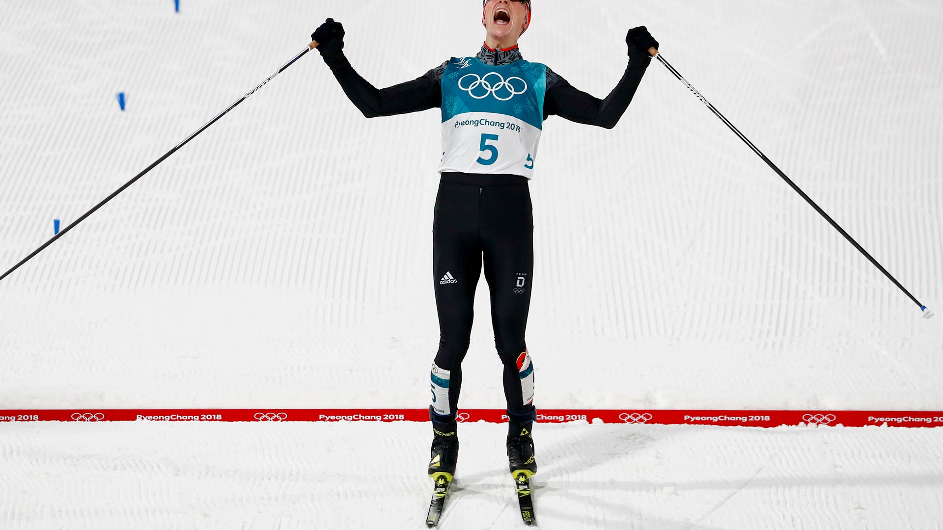Eric Frenzel, of Germany celebrates after winning the the gold medal in the men's 10km cross-country race at the Winter Olympics