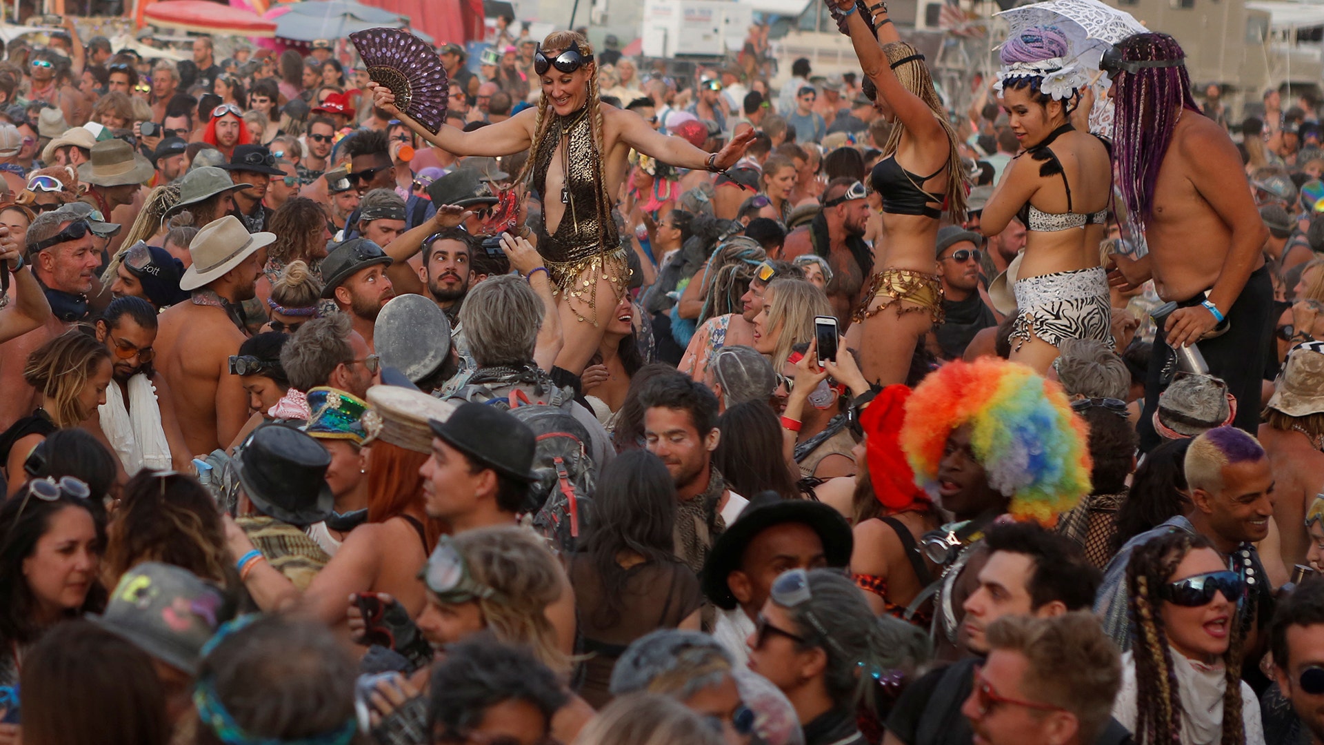 Participants dance on the playa at the annual Burning Man arts and music festival in the Black Rock Desert of Nevada, August 29