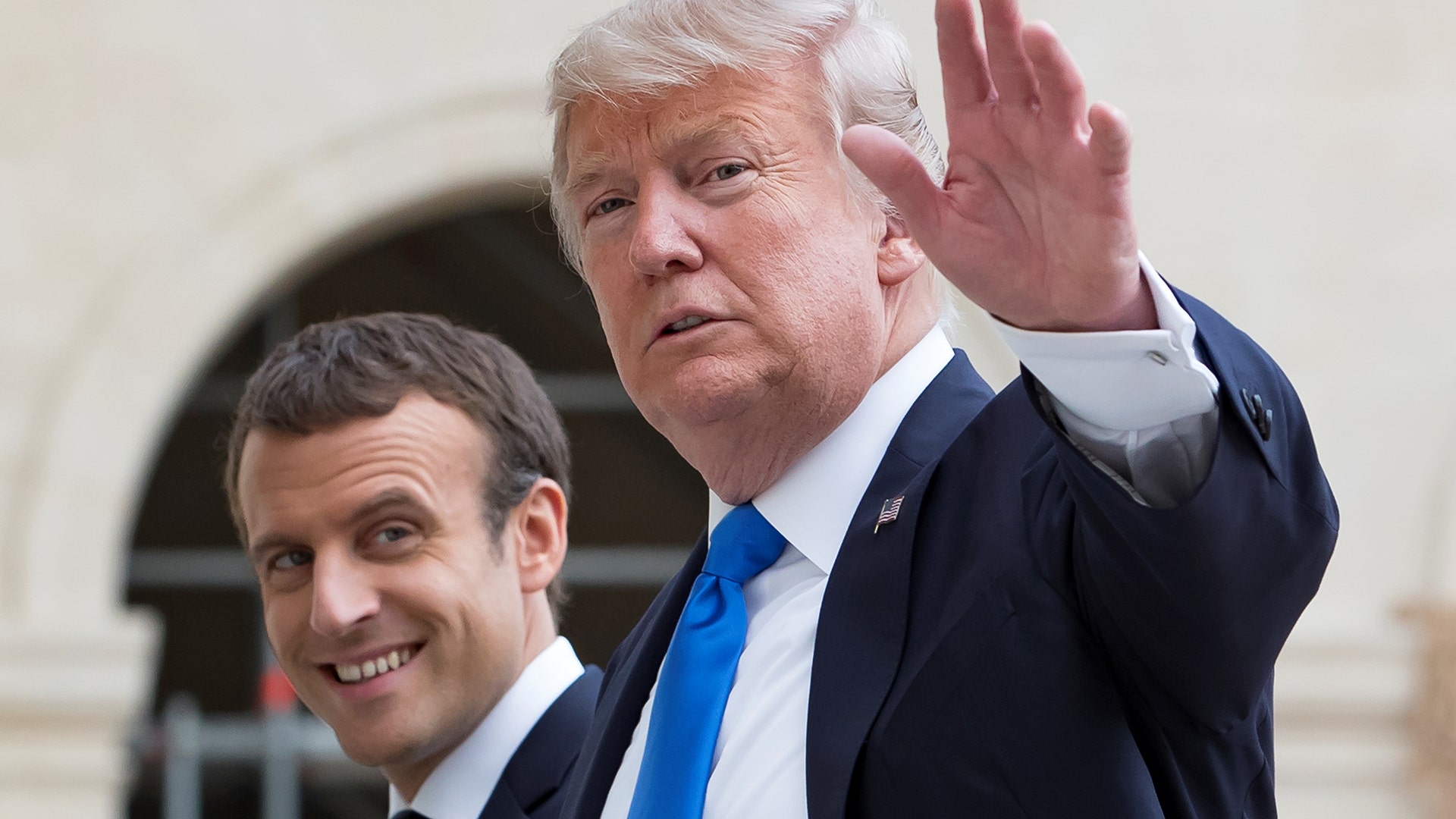 French President Emmanuel Macron and U.S. President Donald Trump leave Les Invalides museum in Paris, Thursday