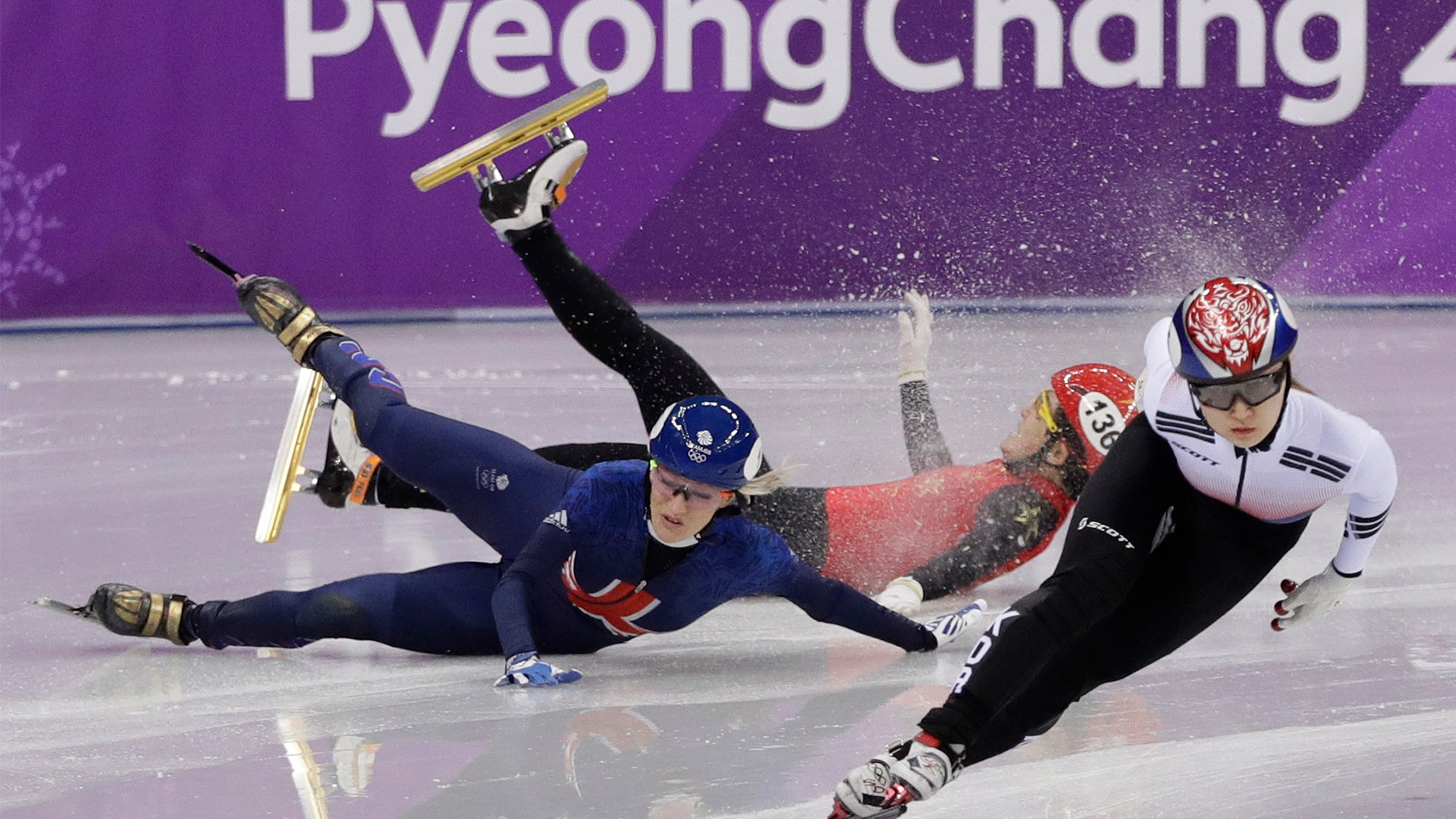Choi Min-jeong races ahead of Elise Christie and Li Jinyu during the 1500 meters short track