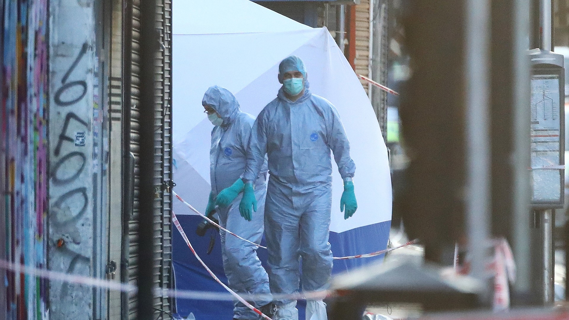 Forensic and police officers attend to the scene after a vehicle collided with pedestrians in the Finsbury Park neighborhood of London