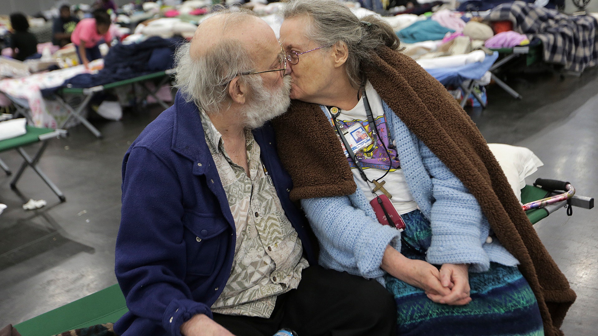 Don and Peg Sauter kiss as they take refuge from Tropical Storm Harvey at the George R. Brown Convention Center in Houston, Tuesday