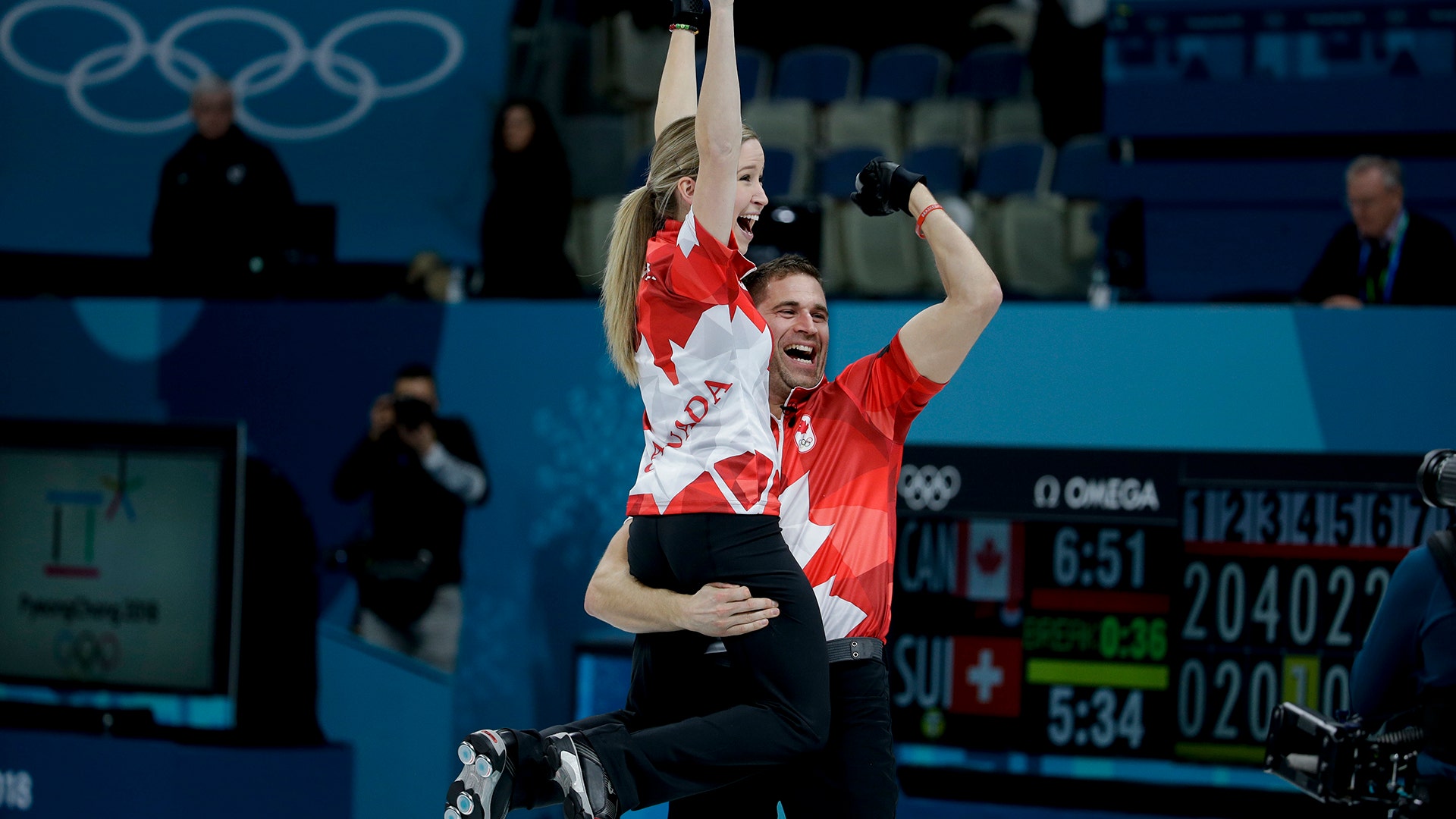 Canada's Kaitlyn Lawes and John Morris celebrate winning the gold medal in mixed doubles curling at the 2018 Winter Olympics