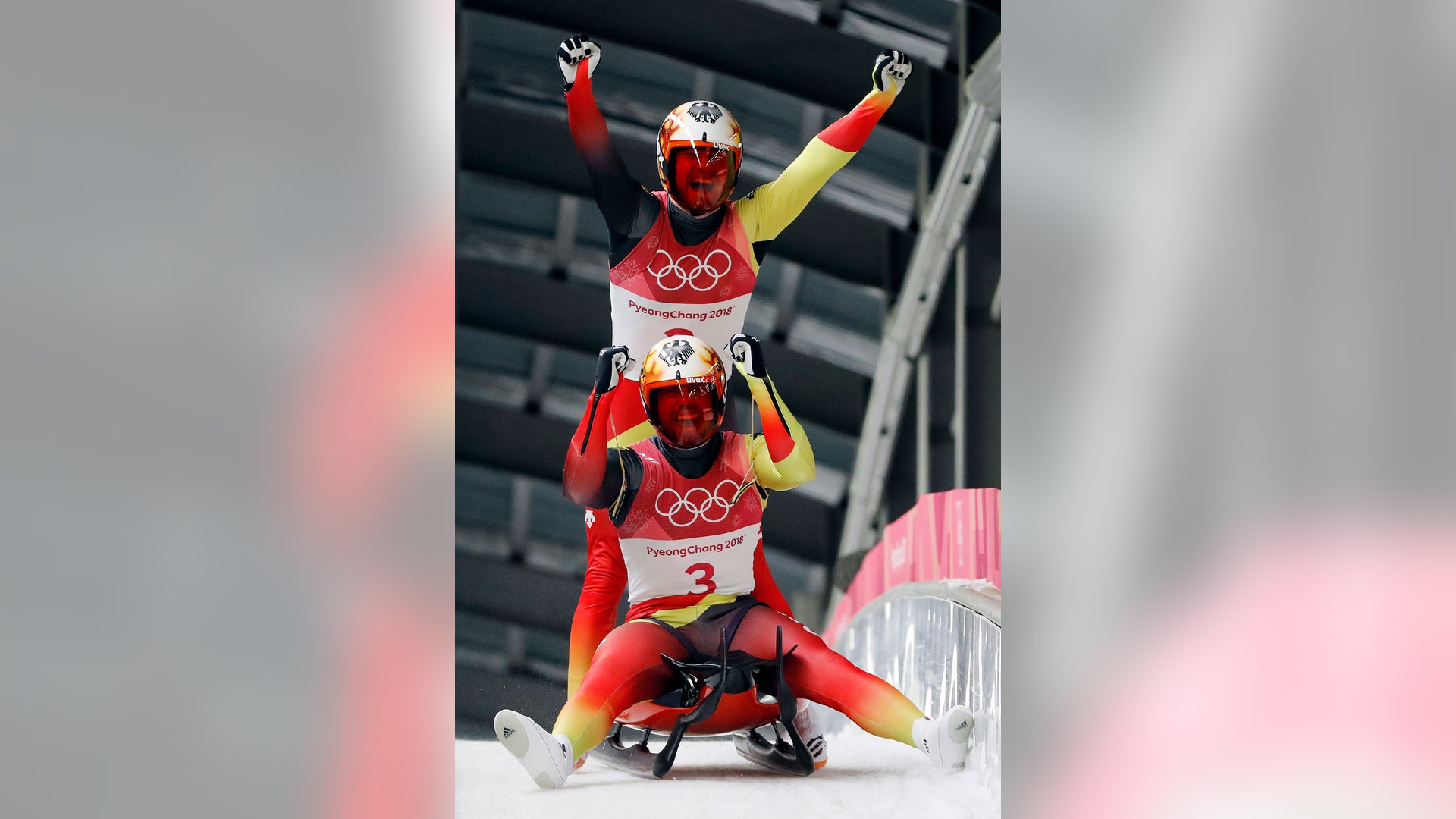 Tobias Arlt and Tobias Wendl of Germany celebrate their gold medal winning run in men's double luge at the Winter Olympics