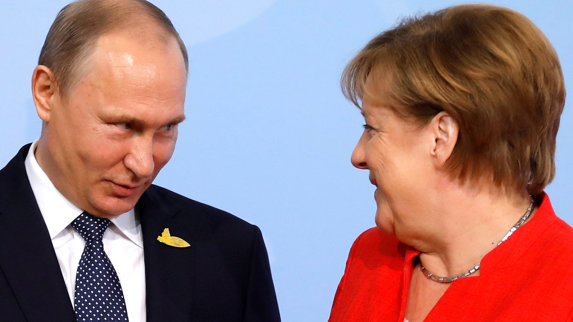 German Chancellor Angela Merkel welcomes Russia's President Vladimir Putin at the G-20 summit in Hamburg, Germany 
