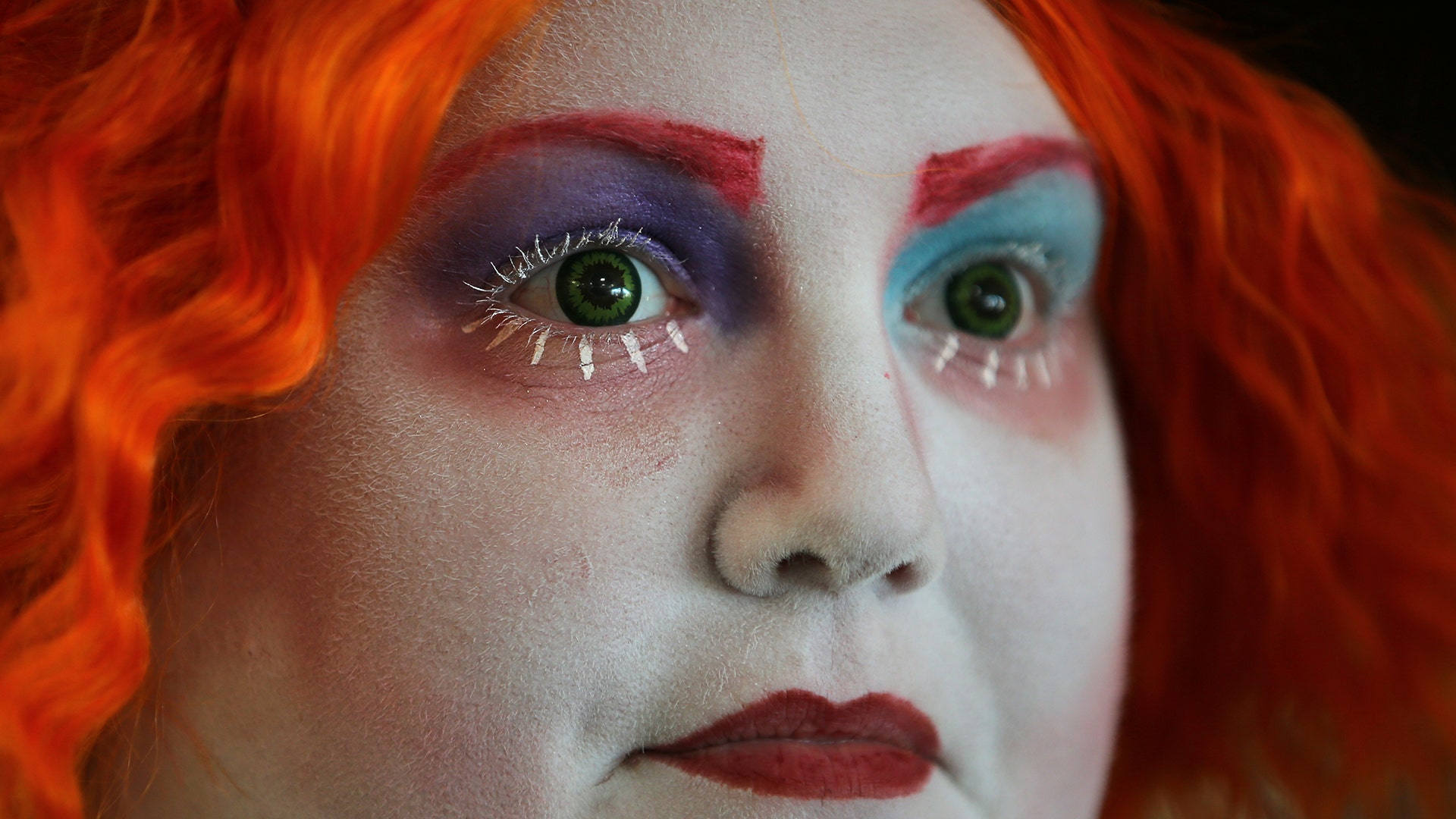Attendee with red hair and green eyes in costume during opening day of Comic-Con International in San Diego