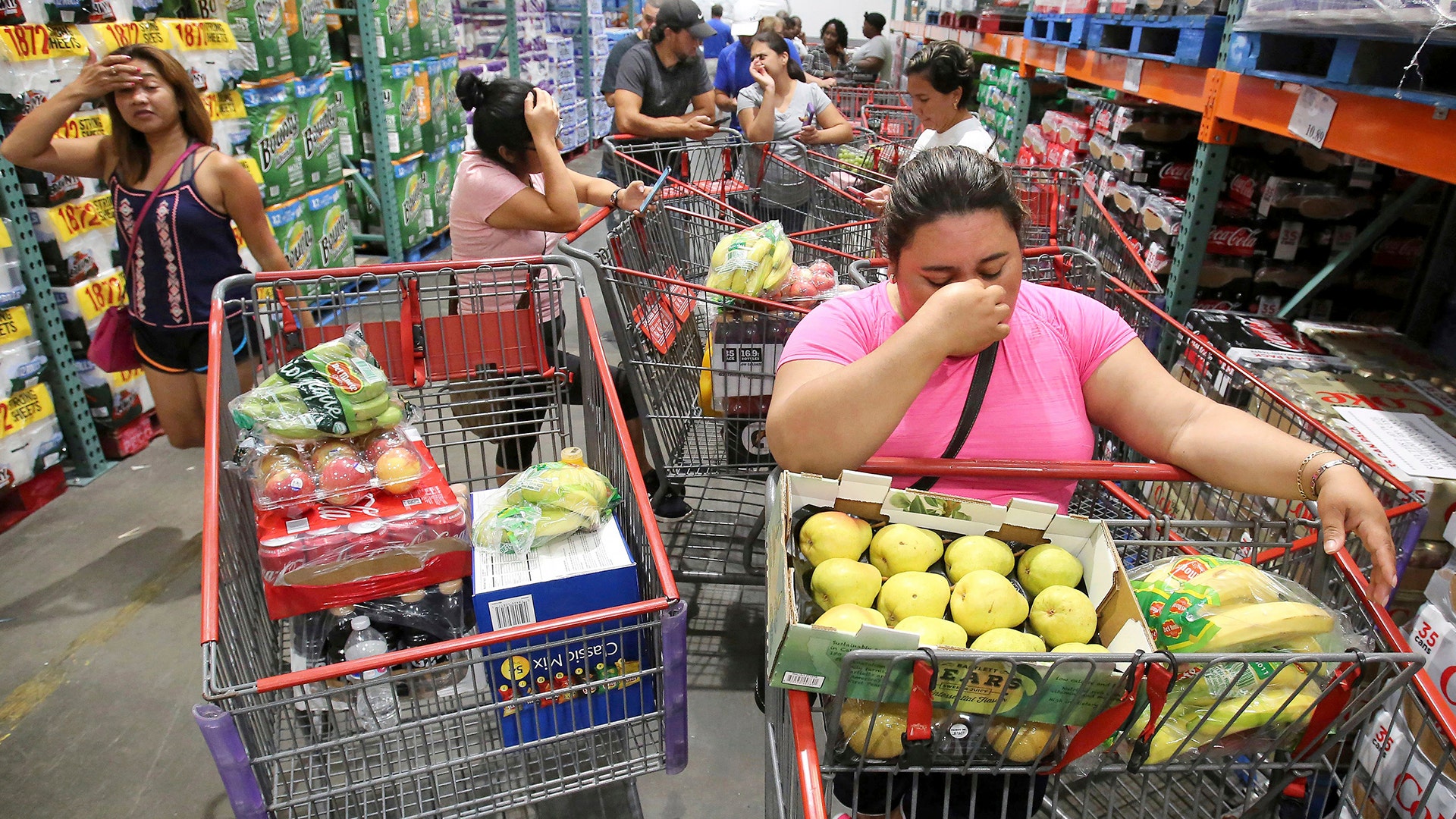 Shoppers wait in line for a shipment of water during preparations for the arrival of Hurricane Irma, Wednesday, Altamonte Springs, Fla