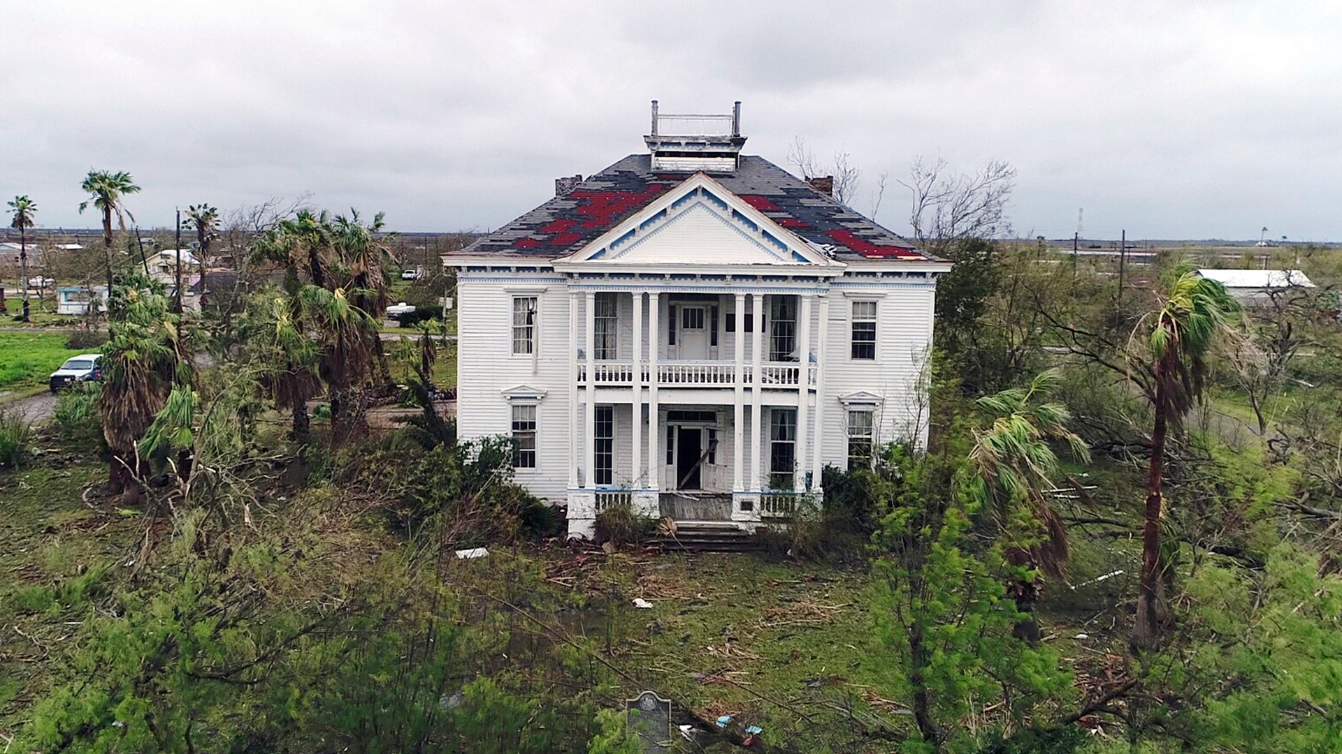 Debris lies on the ground outside the historic John H. Wood and Nancy Clark Wood House in Bayside, Texas, Monday