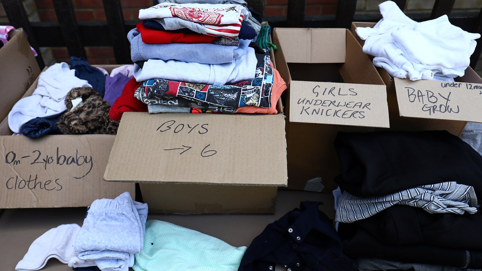 Clothing is laid out for residents of the apartment building destroyed by the fire in West London