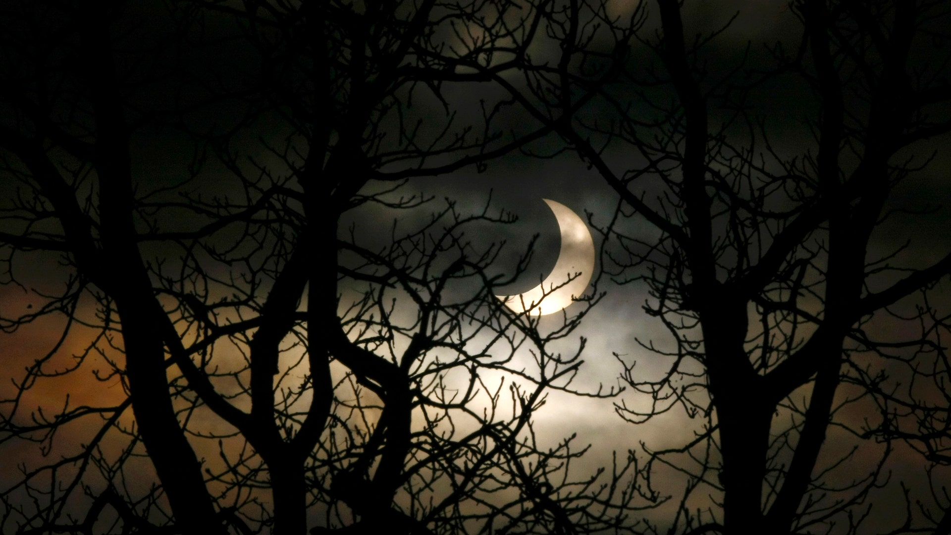 A partial solar eclipse is seen over the city of Warsaw, Poland, January 4, 2011