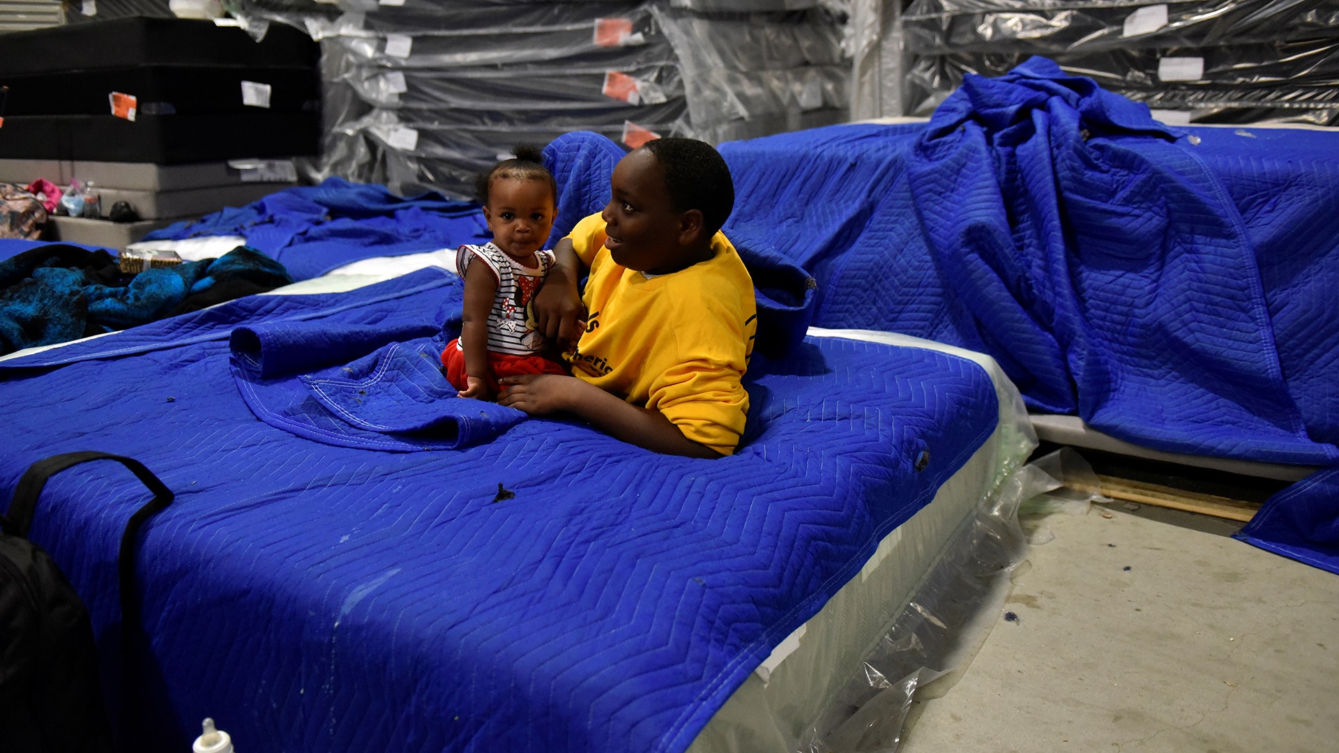 Jakobe Thomas with his sister Journey Thomas at Gallery Furniture where they were evacuated to in Houston, Tuesday