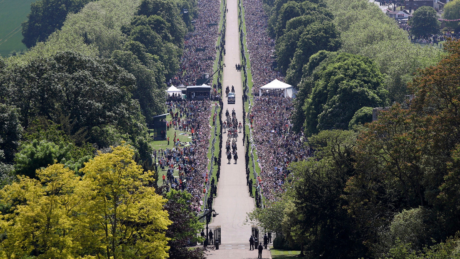 Prince Harry and Meghan Markle ride in a carriage down the Long Walk after their wedding ceremony