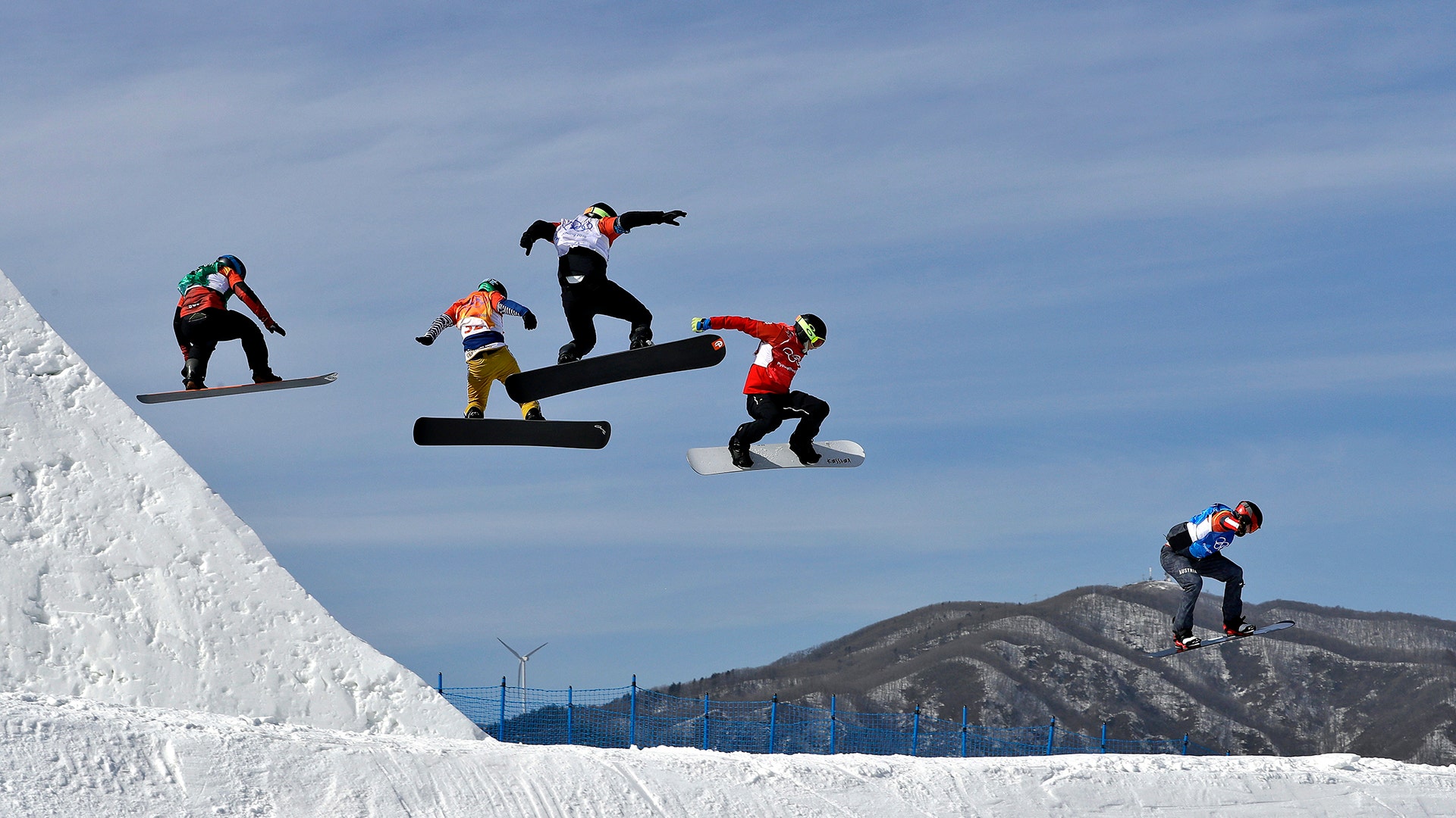 Competitors in the the men's snowboard cross elimination round at the 2018 Winter Olympics in Pyeongchang