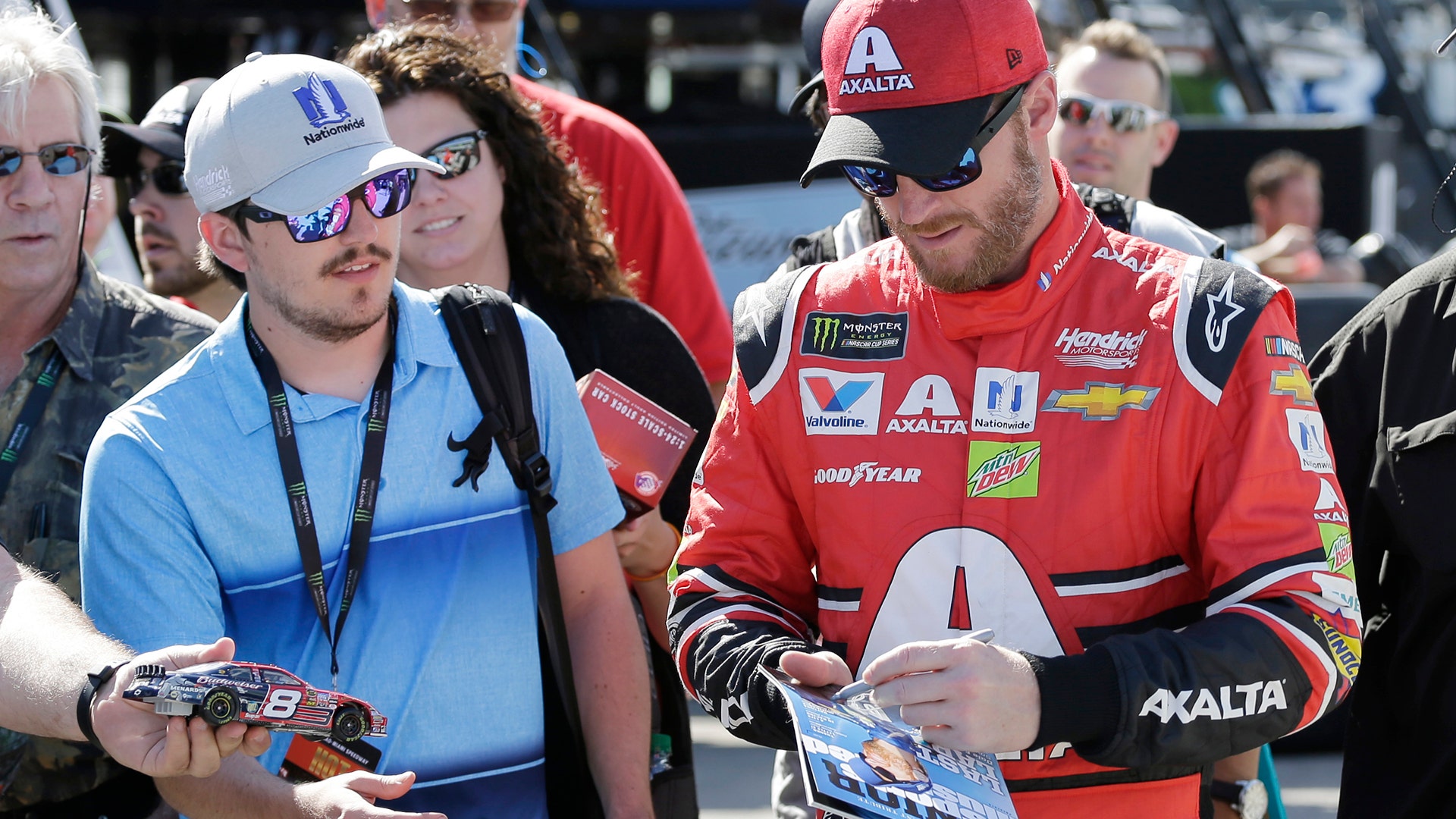 Dale Earnhardt Jr., gives autographs during practice for Sunday's NASCAR Cup Series auto race at Homestead-Miami Speedway , Nov. 17