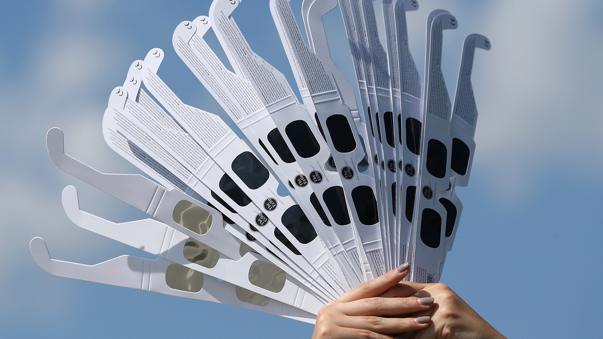 Ashley Ann Sander sells solar eclipse glasses for $10 a pair near near Clayton, Ga., Sunday, August 20