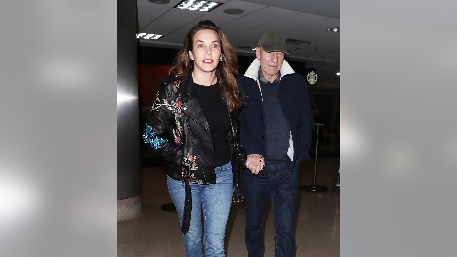 77-year-old Patrick Stewart and his 39-year-old wife Sunny Ozell hold hands while making their way through LAX. January 9, 2018 X17online.com