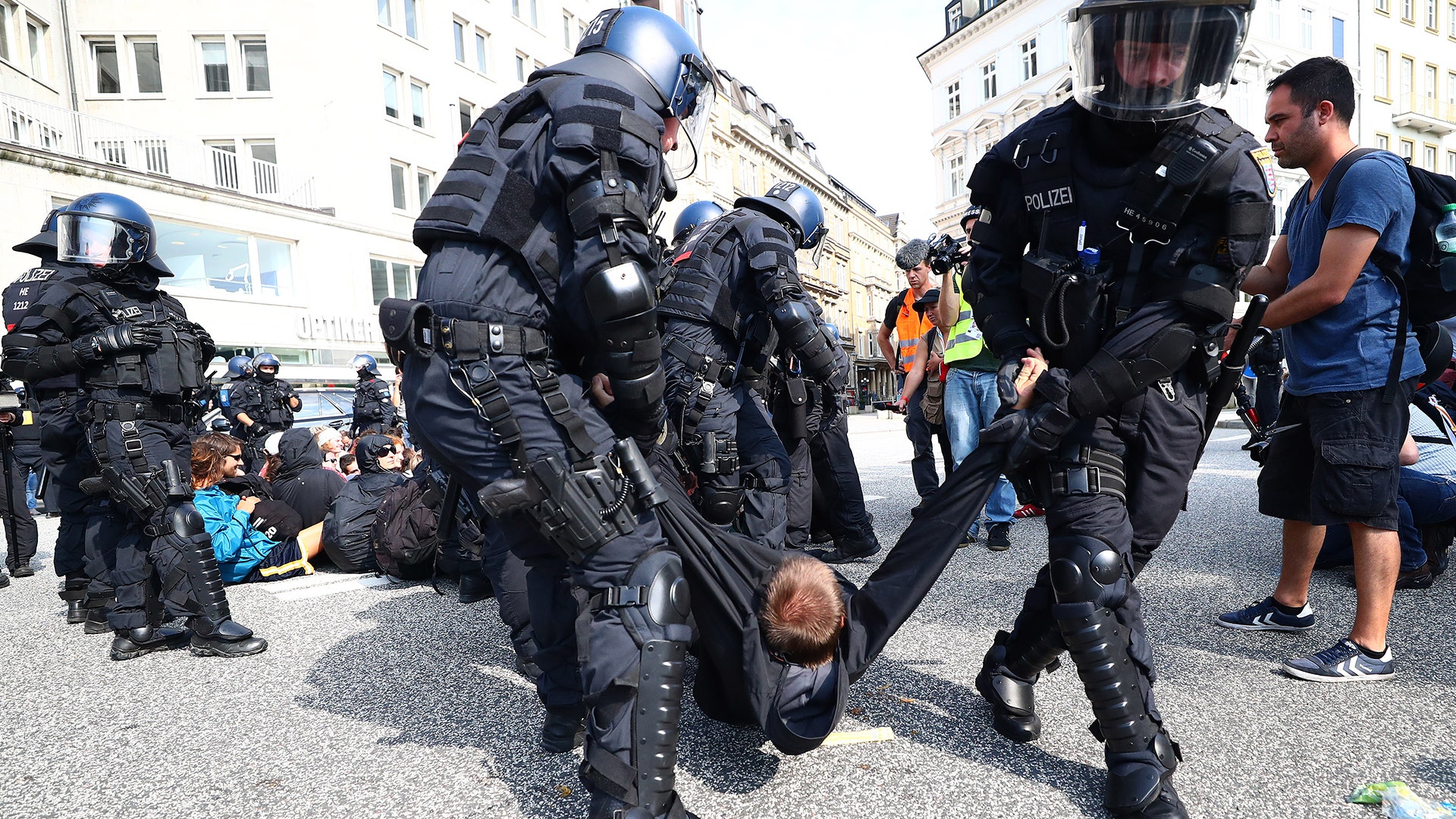 German police remove protesters who blocked a street during a demonstration at the G20 summit in Hamburg, Germany, July 7