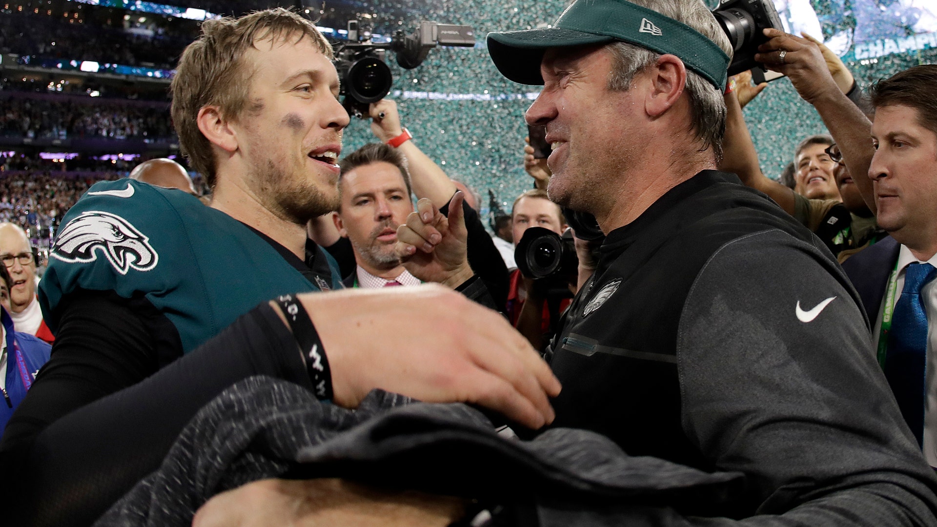 Philadelphia Eagles' quarterback Nick Foles celebrates with head coach Doug Pederson after winning Super Bowl 52