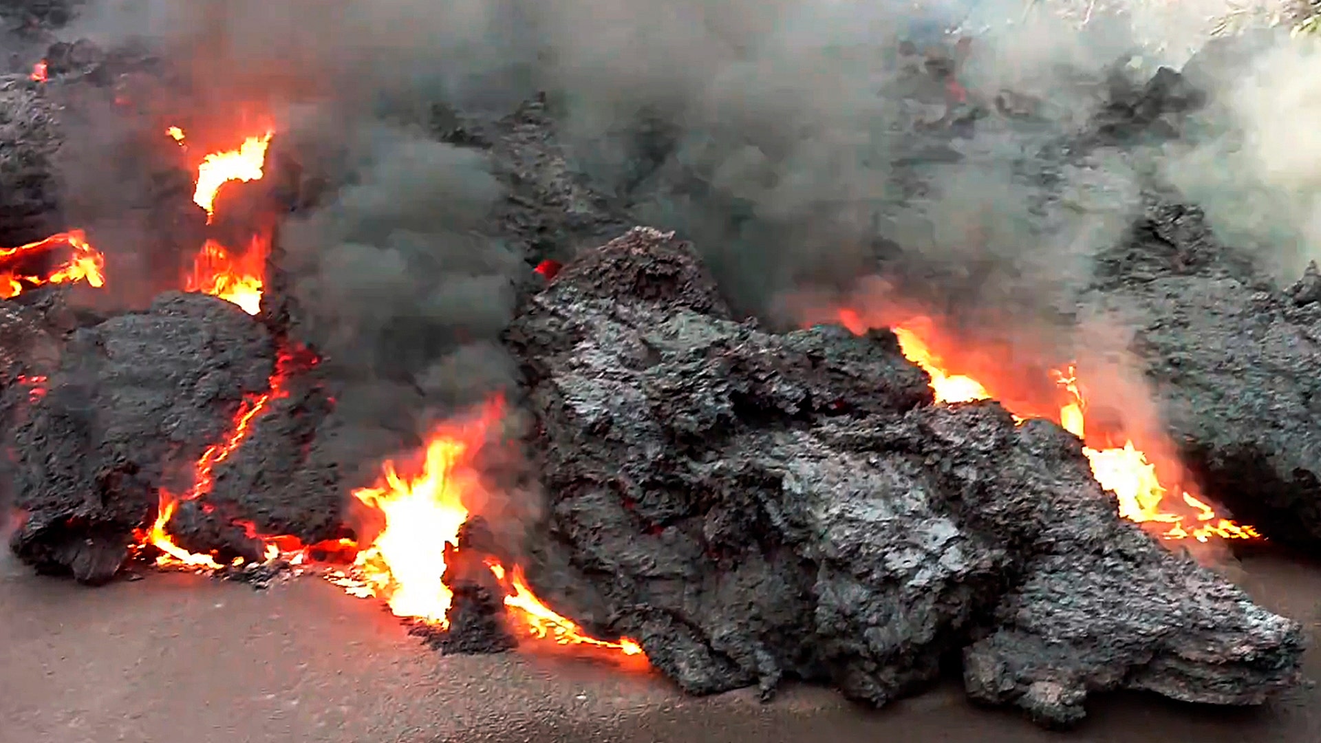 A lava flow advancing down a road is seen from less than 10 feet away in the Leilani Estates subdivision near Pahoa, Hawaii, May 7, 2018