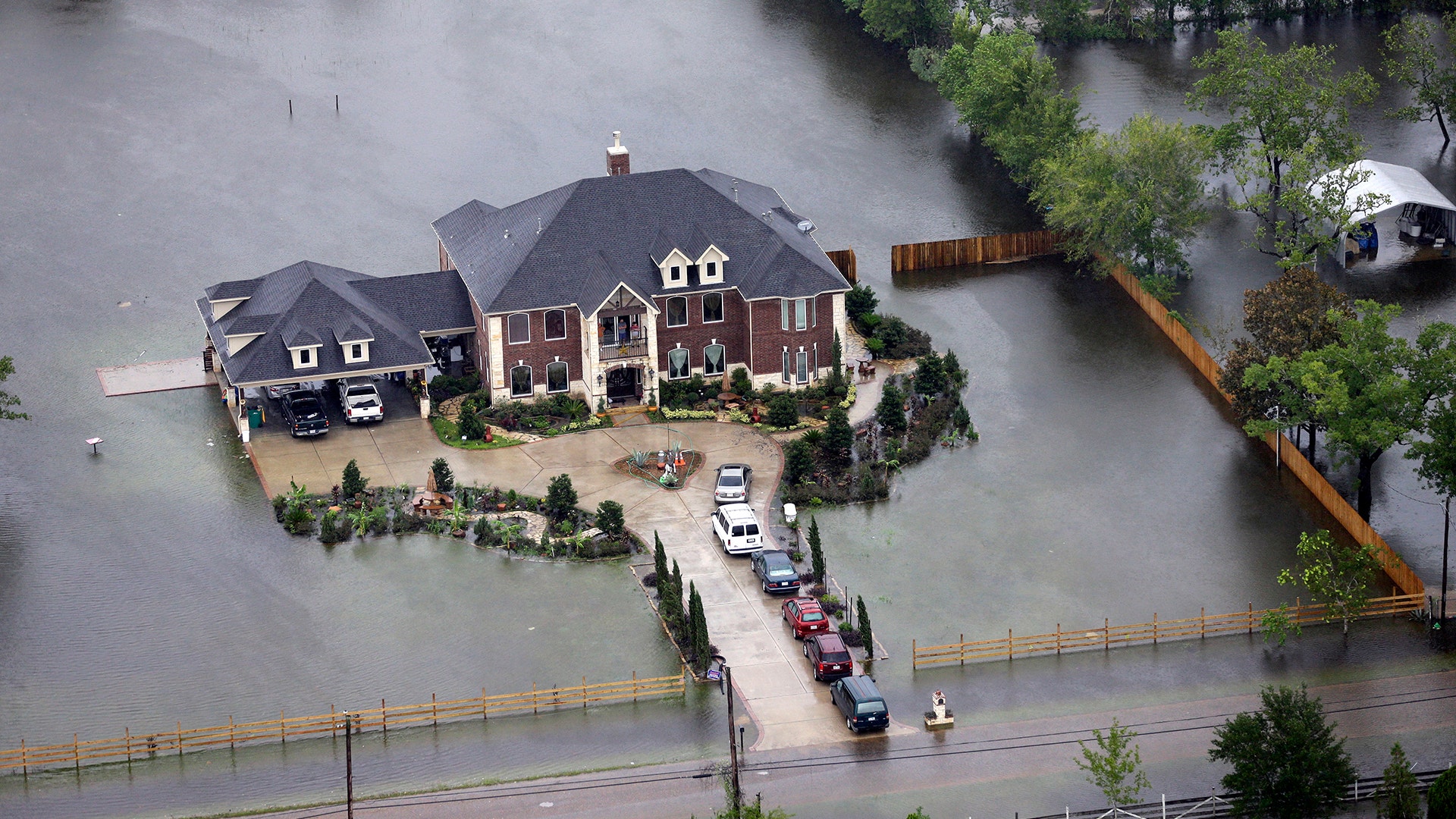 A home is surrounded by floodwaters from Tropical Storm Harvey in Houston, Tuesday