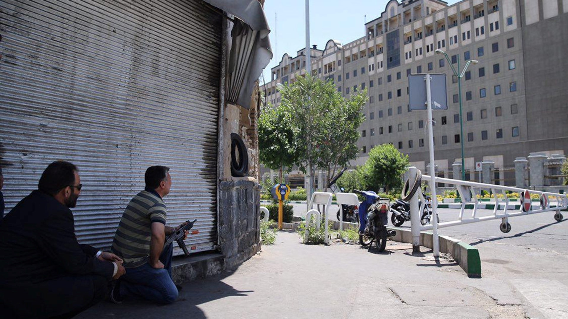 Members of Iranian forces take position during an attack on the Iranian parliament