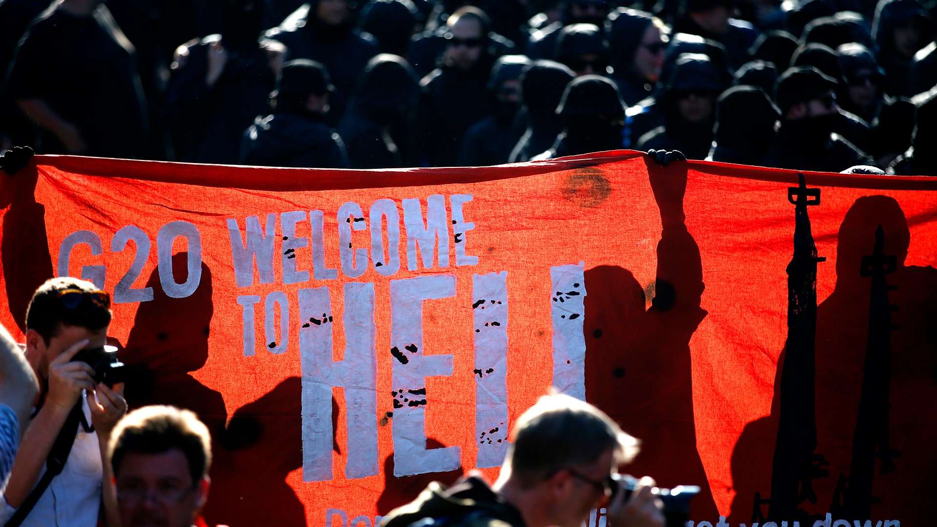 Protesters hold a placard during a demonstration at the G-20 summit in Hamburg, Germany