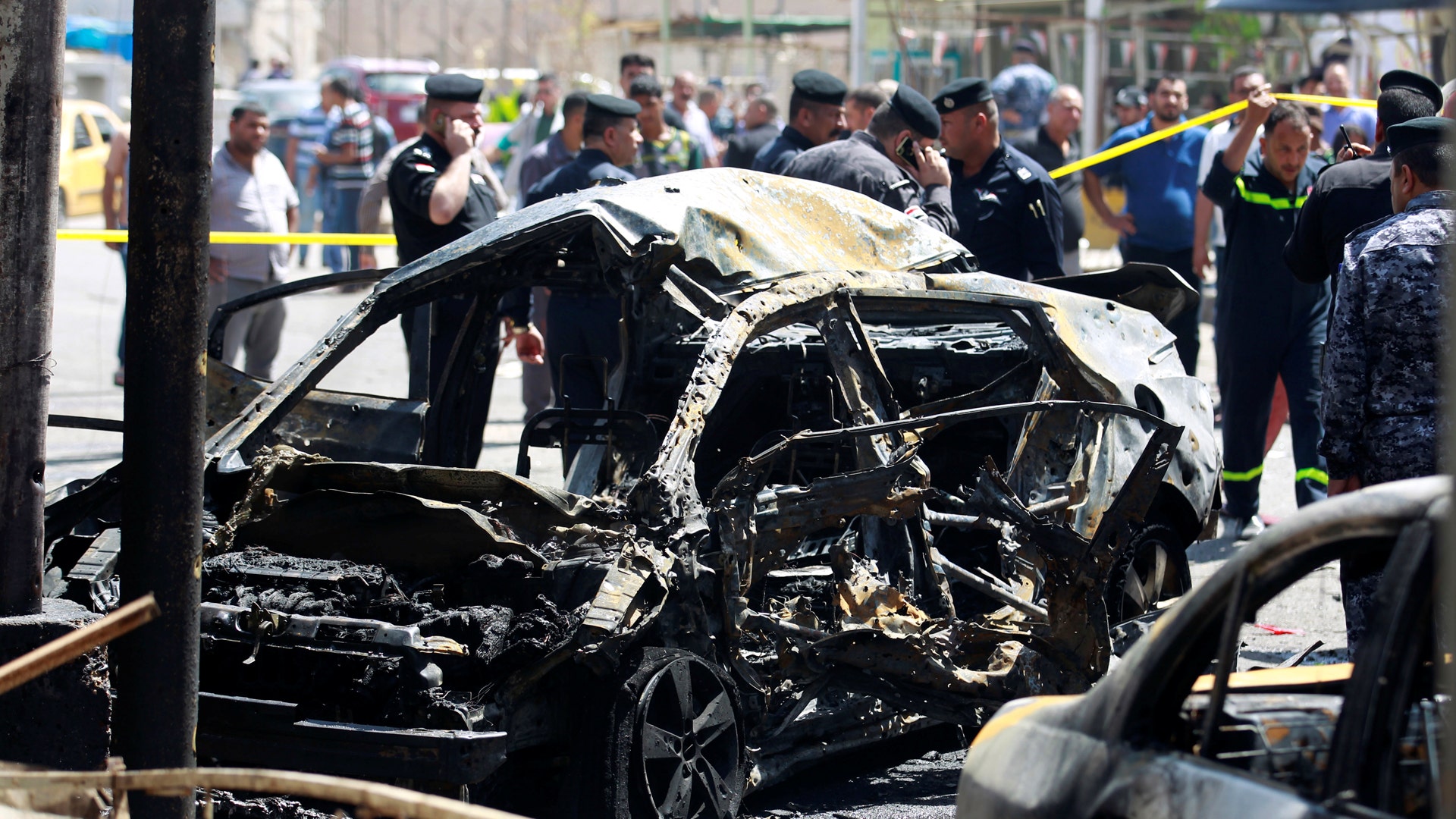 A wreckage of a car is seen at the site of car bomb attack in Baghdad
