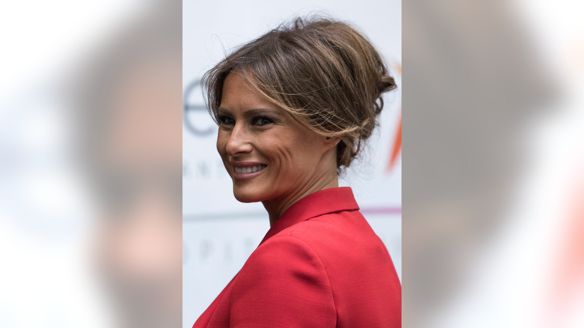 First Lady Melania Trump smiles visits the Necker hospital, France's largest pediatric hospital in Paris